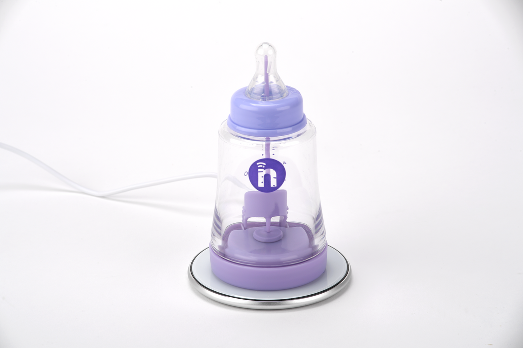 Purple baby bottle device with a clear top on a white background